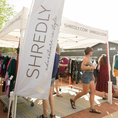 Woman walking away from the SHREDLY tent